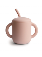Pink silicone cup with a lid and straw, designed for easy drinking. Smooth, rounded shape and two handles.
