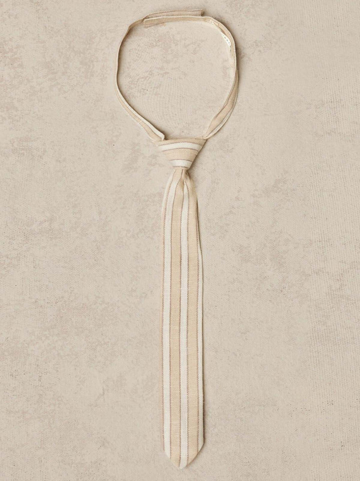 Beige striped tie displayed on a textured background.