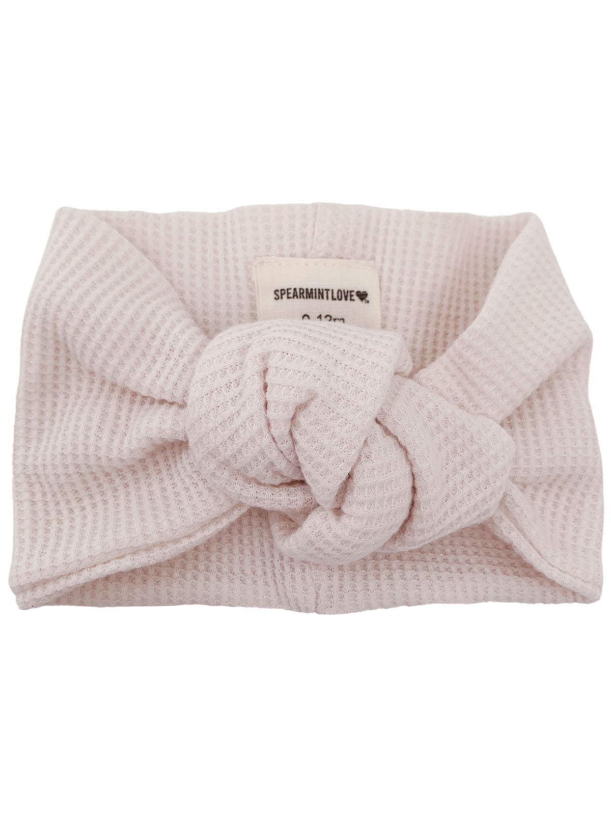 Light pink knot headband with textured fabric, labeled 'SPEARMINTLOVE.' Perfect for infants.