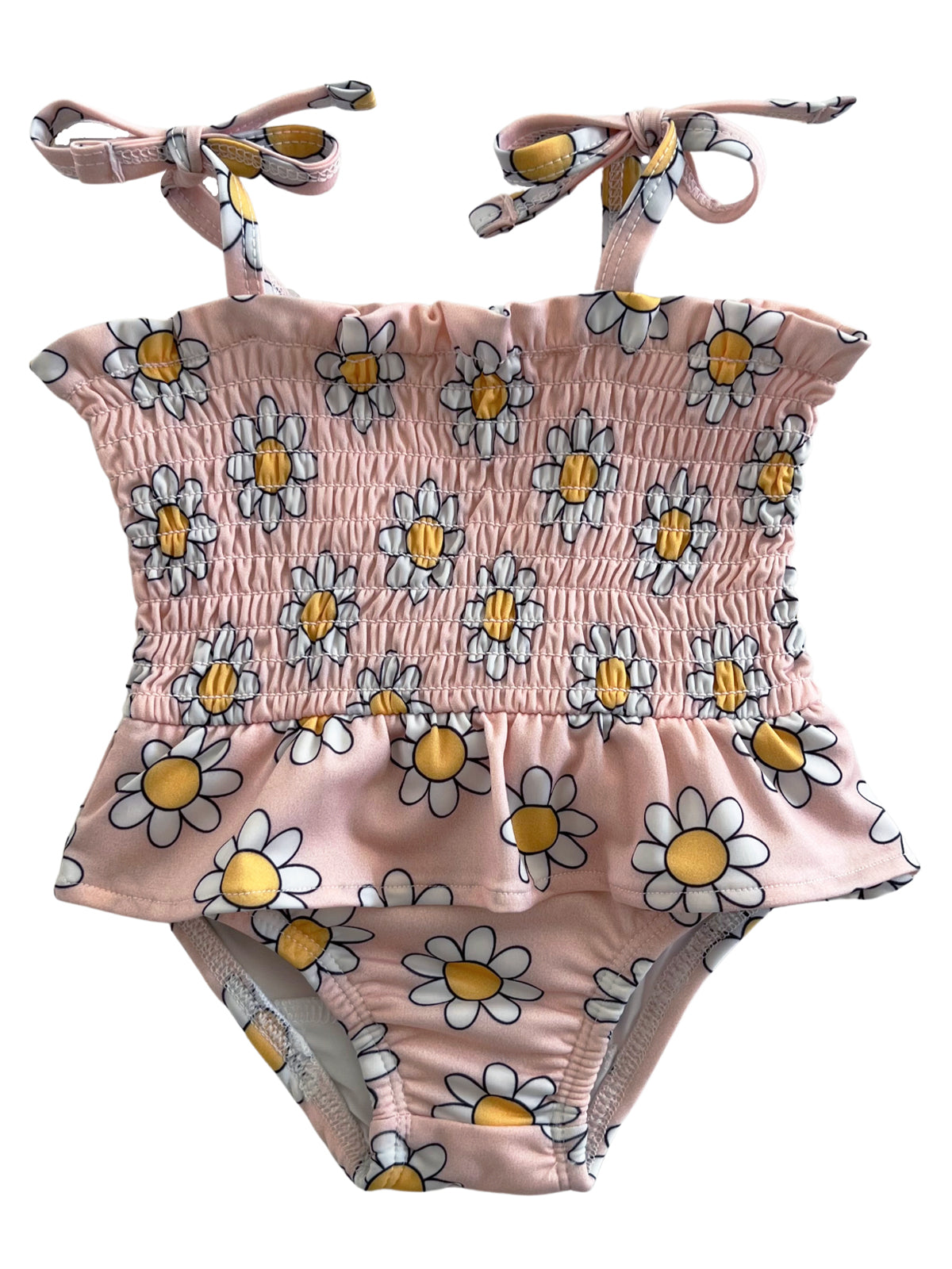 Pink floral swimsuit with smocked bodice and bow straps, featuring white daisies and yellow centers.