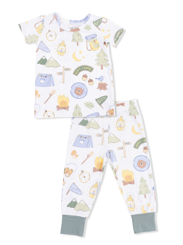 Kids' camping-themed pajamas featuring playful graphics of trees, tents, lanterns, and a bear.