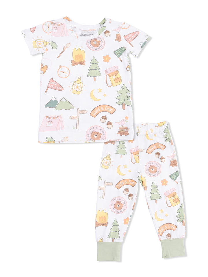 Kids' pajama set featuring camping-themed designs, including trees, lanterns, and playful slogans.