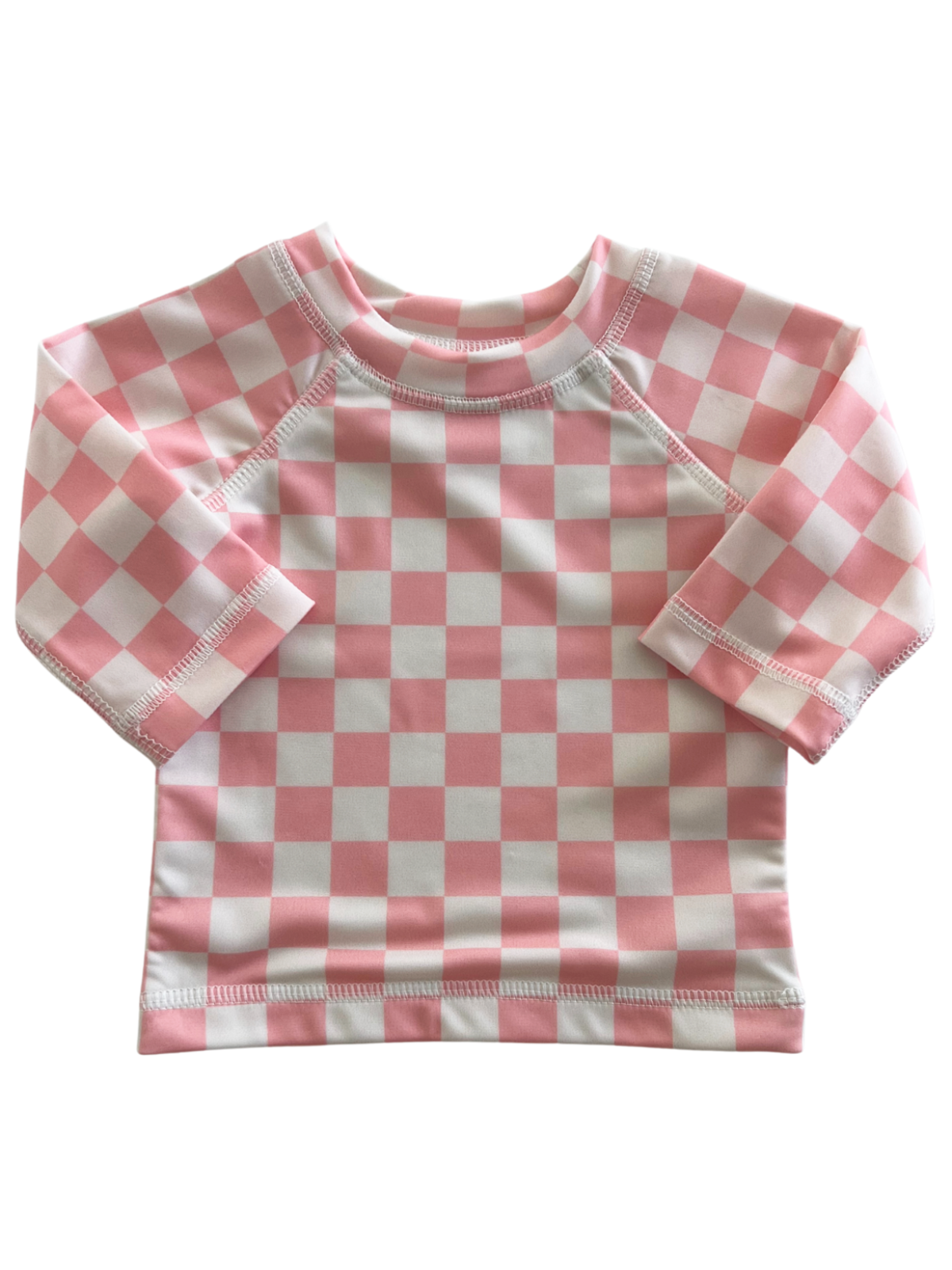 Light pink and white checkered long-sleeve shirt for children, featuring a round neckline and soft fabric.