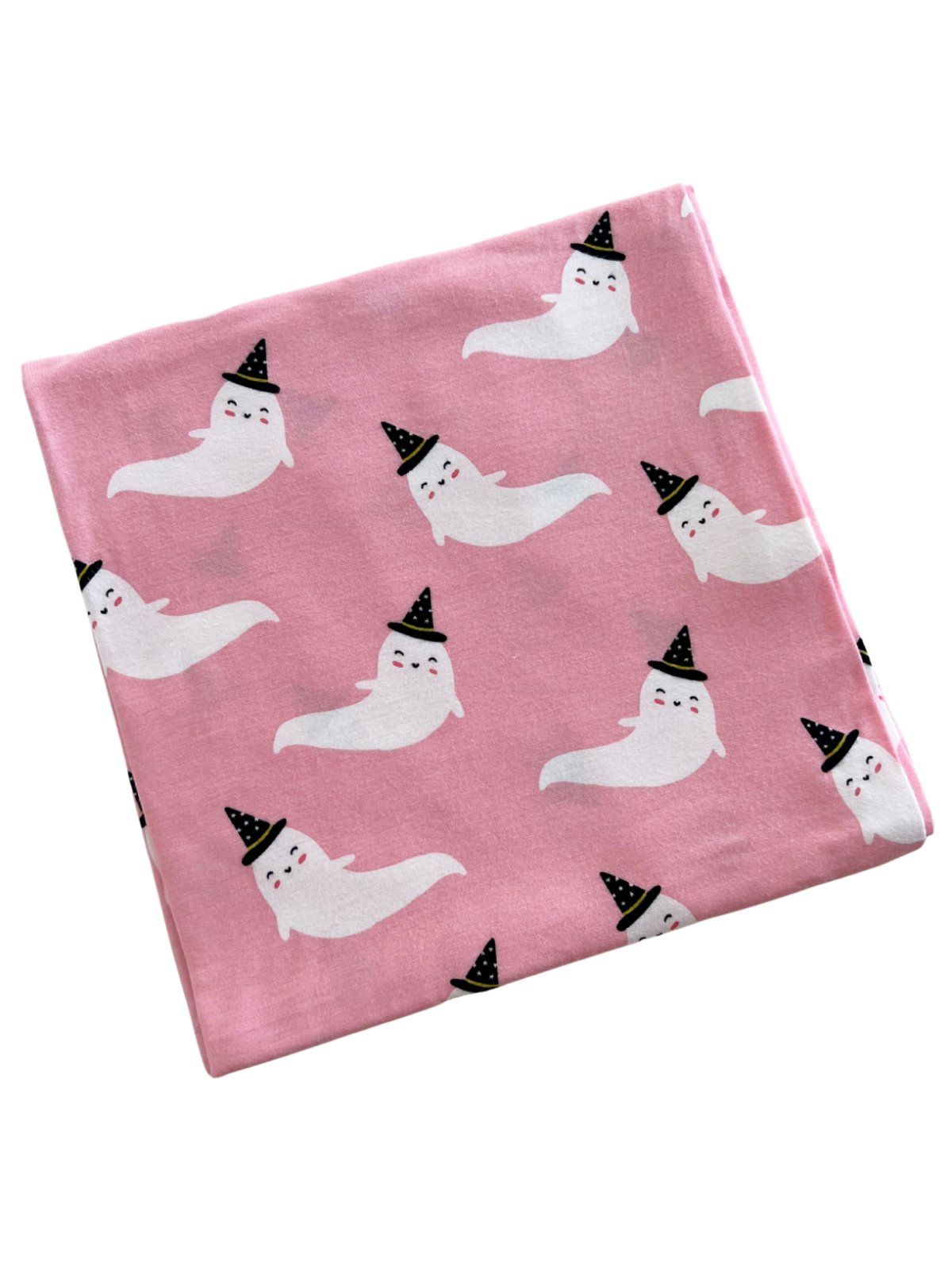 Pink fabric featuring cute, smiling ghosts wearing black party hats in a repeating pattern.