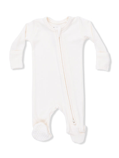 Cream-colored baby onesie with long sleeves and a front zipper, featuring textured feet for grip.
