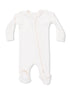 Cream-colored baby onesie with long sleeves and a front zipper, featuring textured feet for grip.