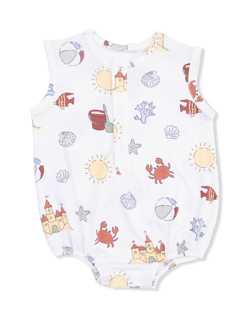 White baby romper with beach-themed prints: crabs, seashells, sun, and castles in pastel colors.
