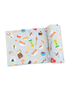 Colorful sushi and Asian food fabric with playful illustrations on a light blue background.