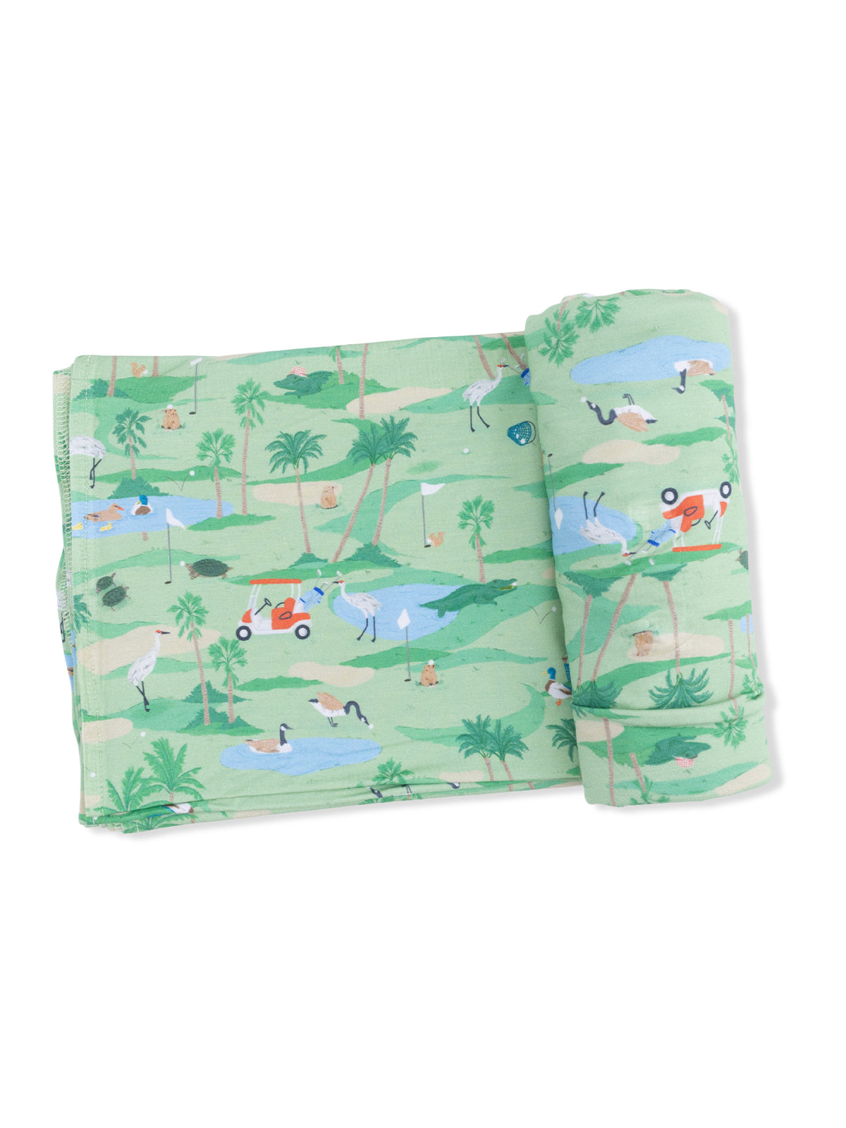 Green fabric featuring a whimsical golf course scene with palm trees, birds, and a golf cart.