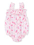 Light pink baby romper with cherry and floral patterns, featuring ruffled straps and elastic leg openings.