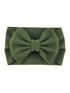 Green textured headband with a large bow, ideal for stylish hair accessories.
