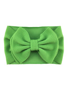 Bright green fabric headband with a large textured bow in the center. Ideal for kids or fashion accessories.