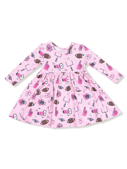 Pink dress with football and cheerleading motifs, featuring long sleeves and a gathered skirt.