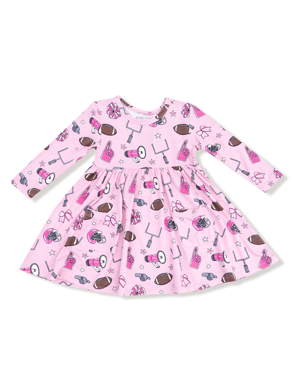 Pink dress with football and cheerleading motifs, featuring long sleeves and a gathered skirt.