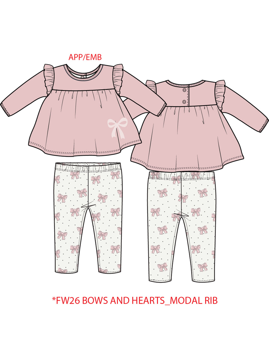 Pink long-sleeve top with ruffles and bow, paired with white pants featuring pink bows and hearts.