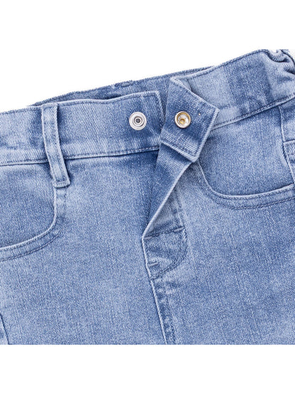 Close-up of light blue denim jeans showcasing the waistband and buttons.