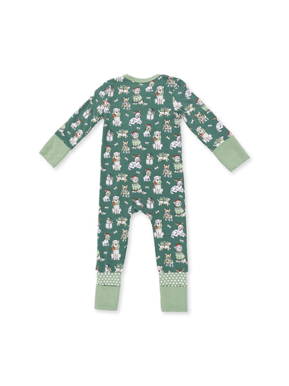 Green pajamas with playful animal patterns in festive attire. Long sleeves and polka dot trim at the ankles.