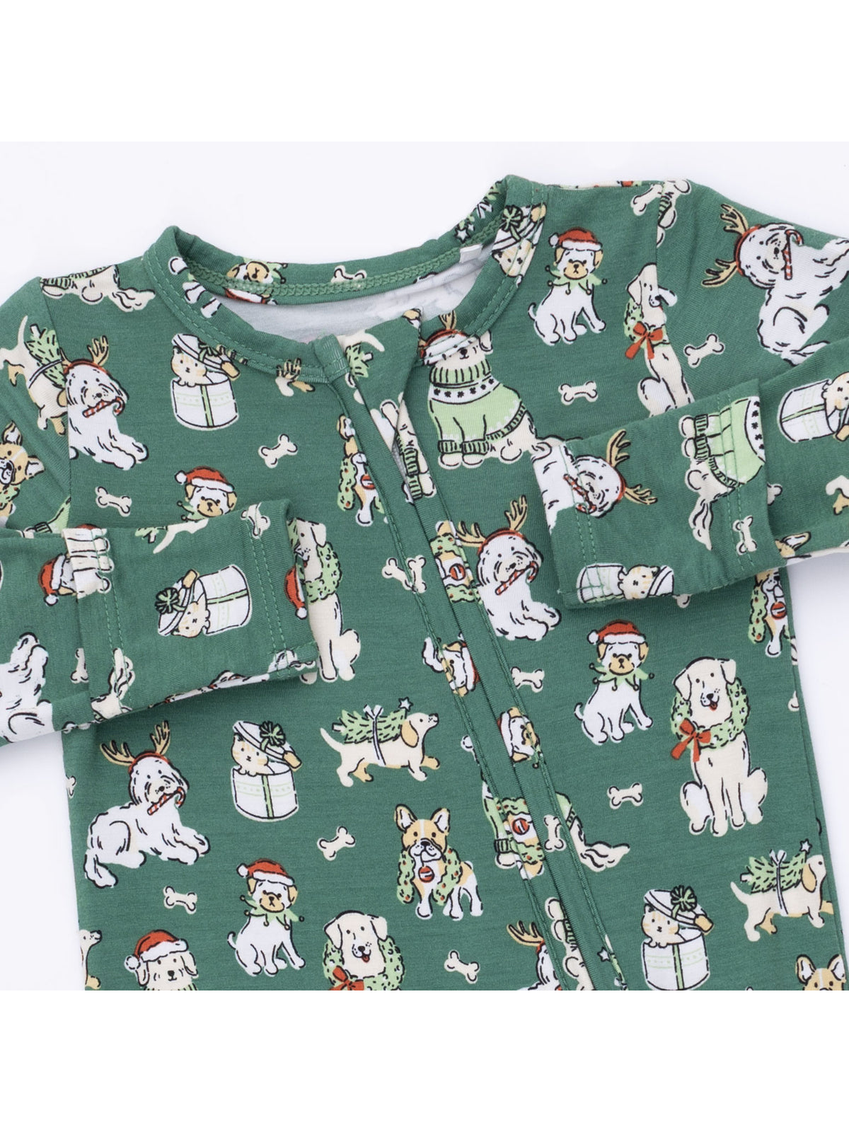 Green baby onesie featuring playful dog illustrations in festive attire.