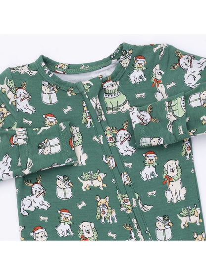 Green baby onesie featuring playful dog illustrations in festive attire.