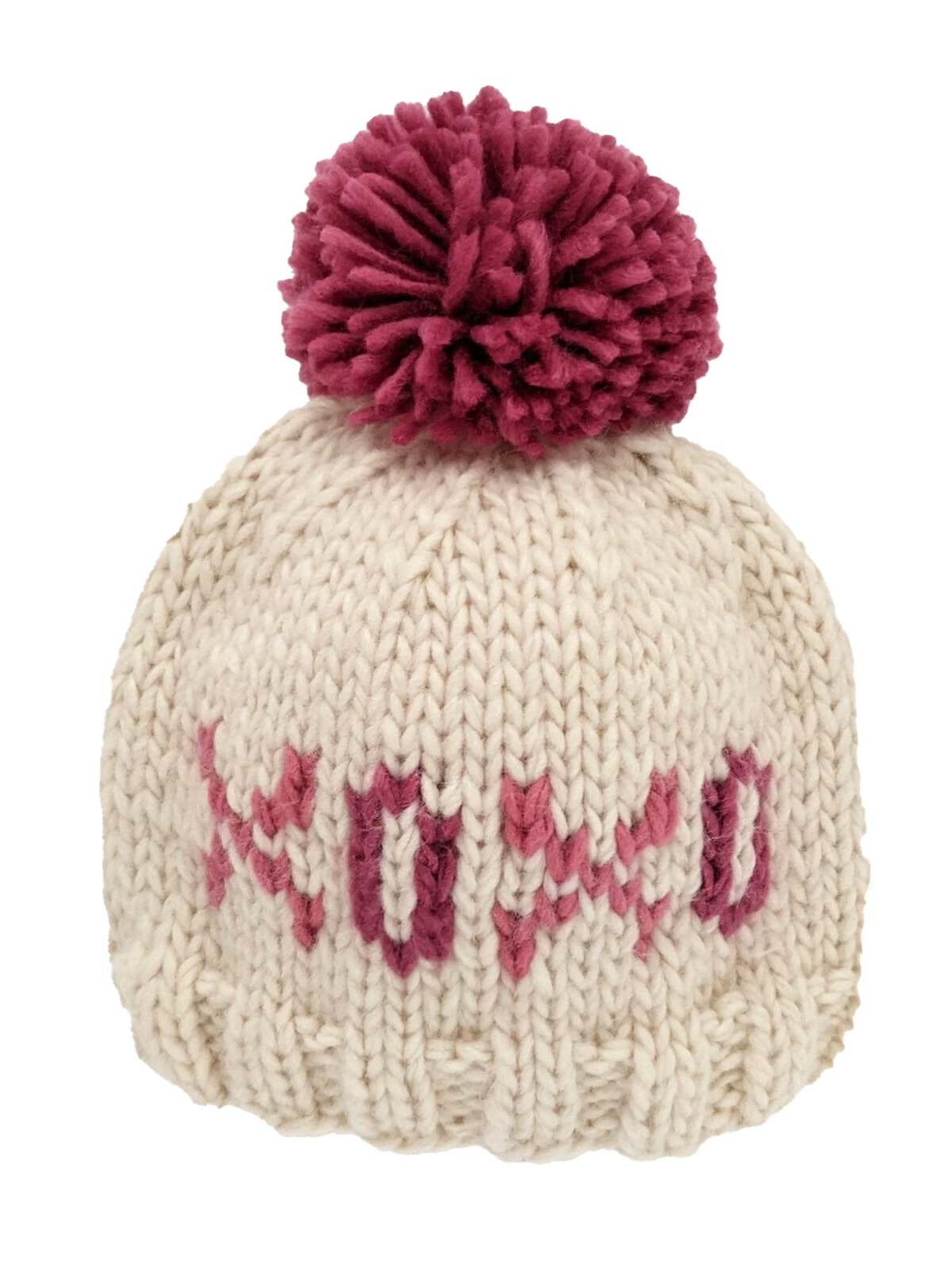 Knit cream beanie with a dark pink pom-pom and the word "XOXO" in shades of pink.