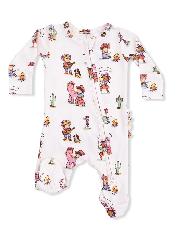 Children's onesie featuring playful cartoon characters, cacti, and campfire motifs in vibrant colors.
