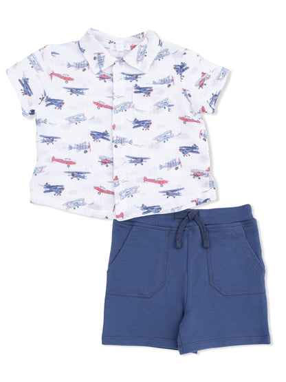 Boys' outfit featuring a short-sleeve airplane print shirt and blue shorts with pockets.