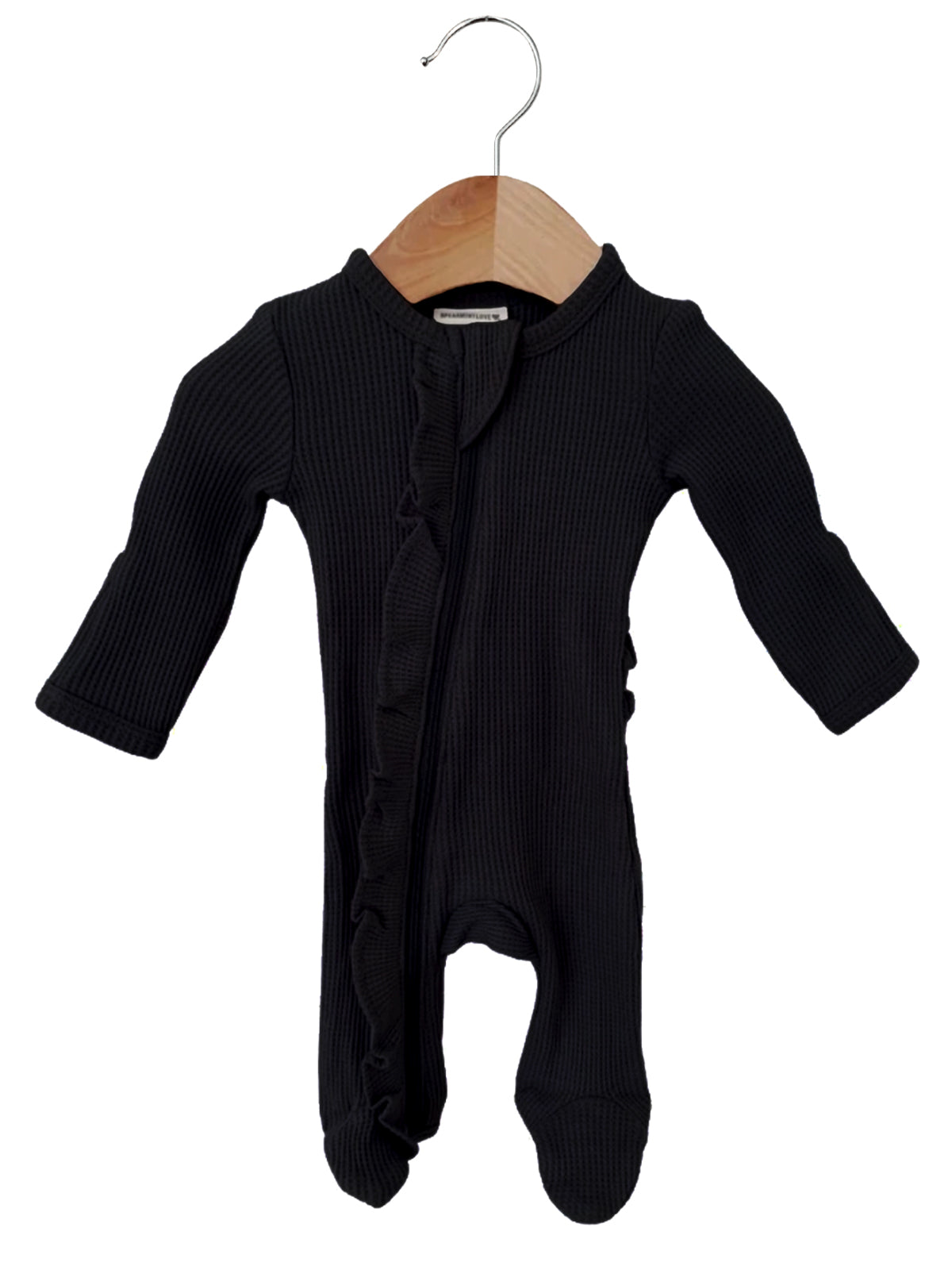Black baby onesie with long sleeves and ruffle details, hanging on a wooden hanger against a white background.