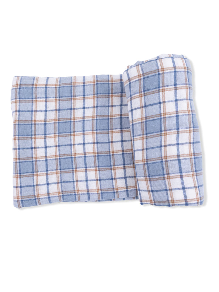 Blue and white plaid blanket folded neatly, featuring light brown accents.