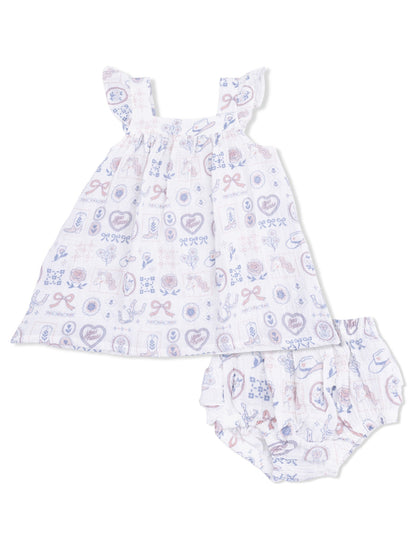 White baby dress with ruffled sleeves and matching bloomers featuring colorful, playful patterns.