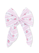 Pink floral-patterned hair bow with striped design and long tails. Perfect accessory for a sweet look.