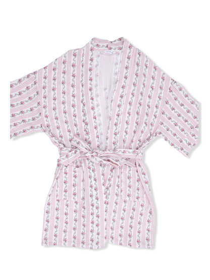 Floral-patterned pink and white robe with a tie closure and wide sleeves, laid flat on a white background.