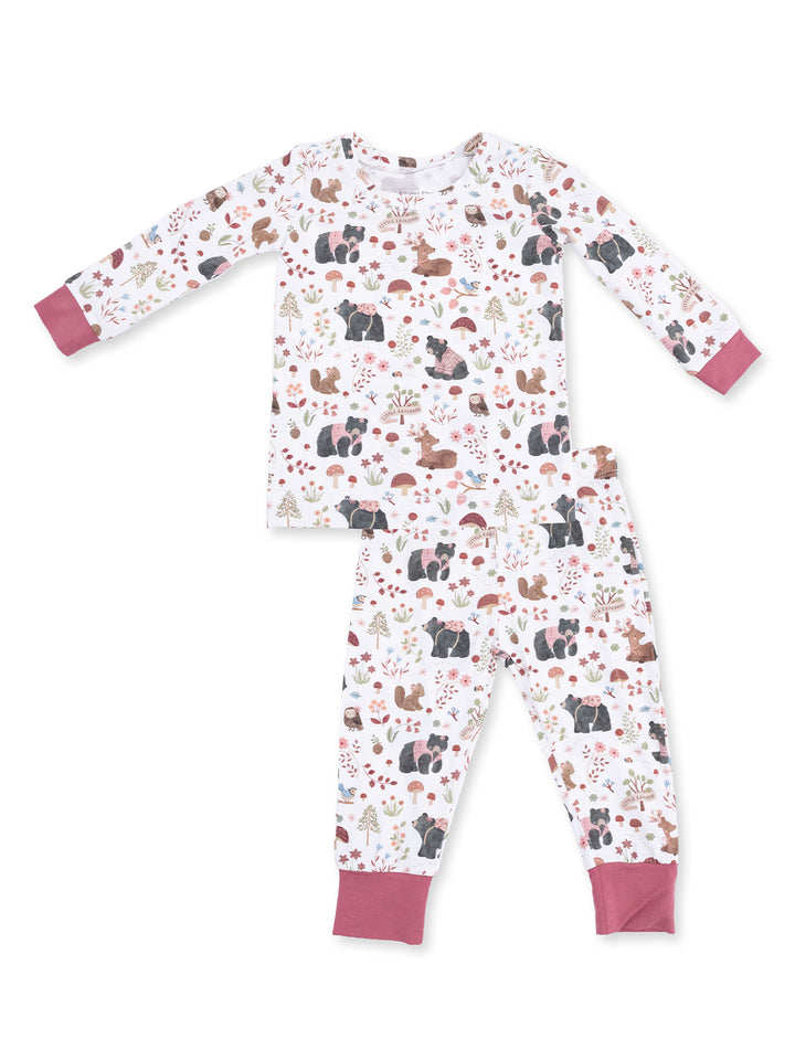 Kids' pajama set featuring playful animal and nature patterns in soft pastel colors.