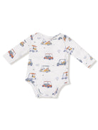 White baby onesie with colorful golf cart prints and long sleeves. Ideal for casual wear.
