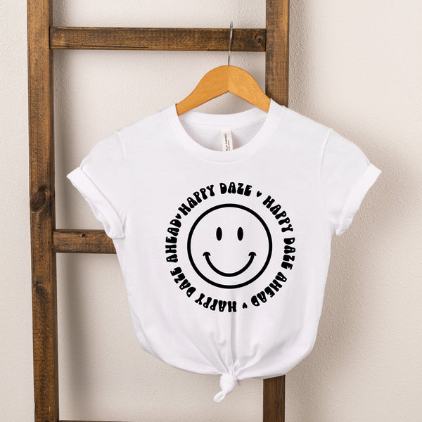 White t-shirt with a smiling face and the text "Happy Daze Ahead" in a circular design.