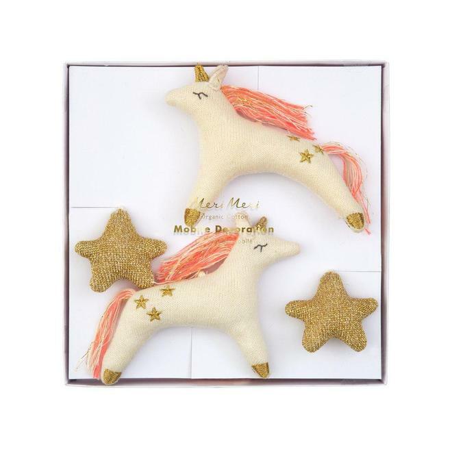 Two unicorn plush toys with pink manes and gold stars, alongside two gold star shapes, in a decorative box.