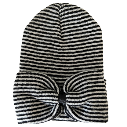 Striped black and white beanie hat with a large bow accent on the front.
