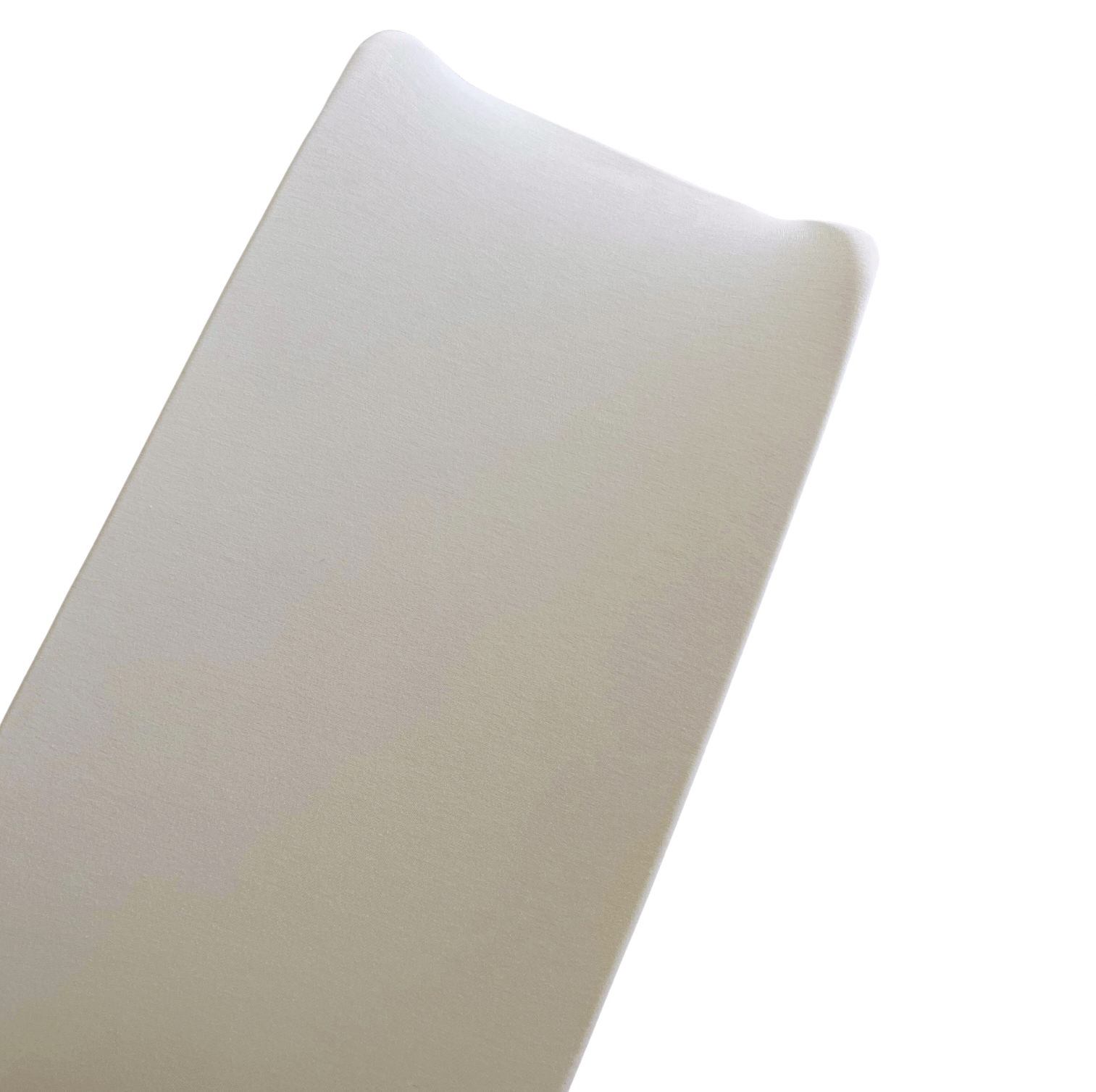 Close-up of a smooth, beige foam mattress corner on a white background.