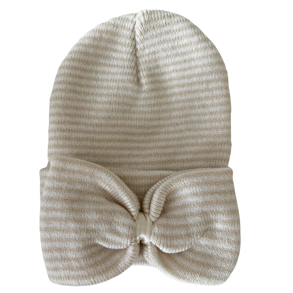 Cream-striped knit beanie with a large bow at the front, perfect for stylish warmth.